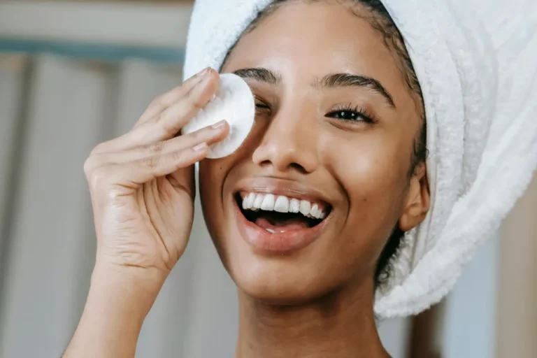 A woman applying a skincare product